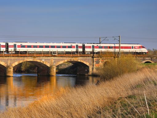 A train over a bridge near Newark you can board with a BritRail Euro GB M-Pass