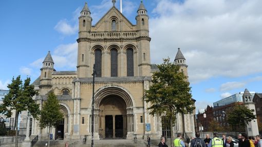 a_group_of_tourists_listening_to_their_guide_during_best_of_belfast_walking_tour