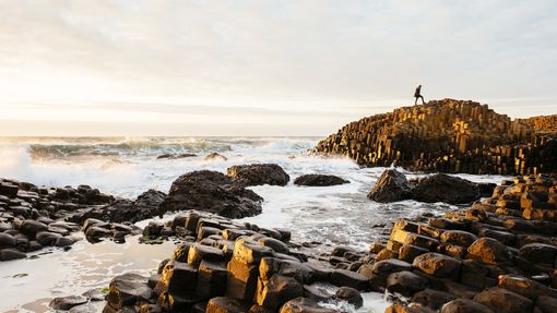 Rock formations coming out of sea. Crashing waves. Dusk