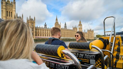 Group of people on board a speed boat on a city river