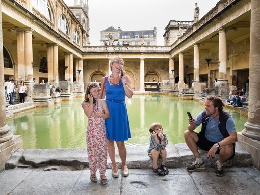 A family visiting the Roman Baths during Golden Tours' Windsor Castle, Bath and Stonehenge tour