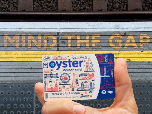 Visitor Oyster card shown next to the mind the gap writing on the platform