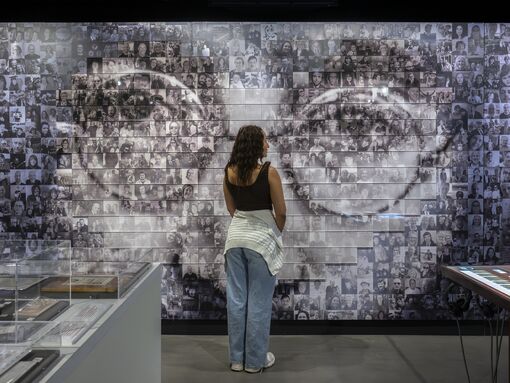 John Lennon Photomosaic wall viewed by a visitor