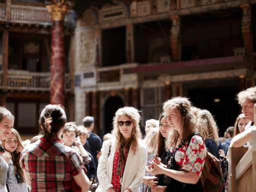 A tour group being guided around Shakespeare's Globe