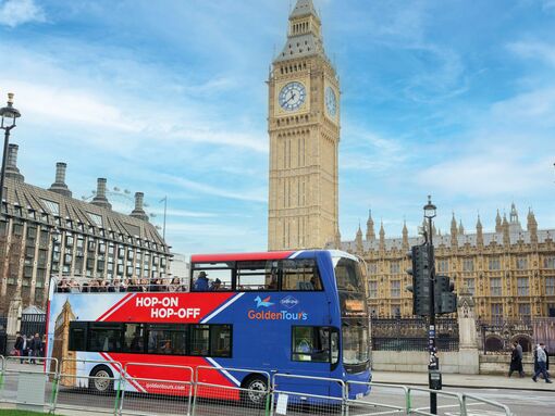 Red and blue bus in front of Big Ben