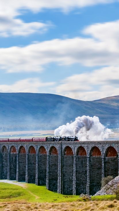 Steam train crossing the Ribblehead Viaduct, Yorkshire Dales, England, UK