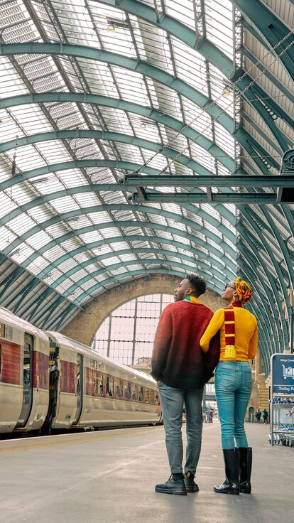 A couple exploring King's Cross Station in London