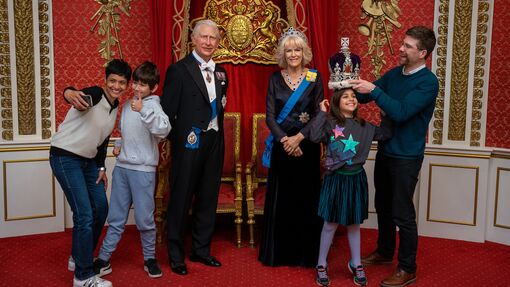 A family having fun in The Royal Palace at Madame Tussauds in London