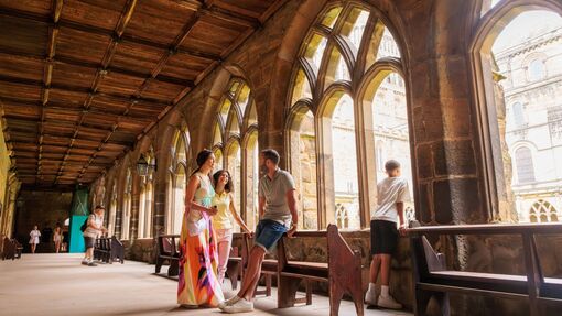 A family walking inside the cloisters of Durham Cathedral