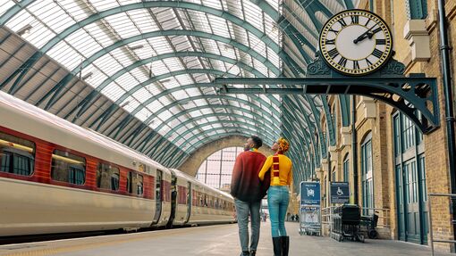 A couple exploring King's Cross Station in London