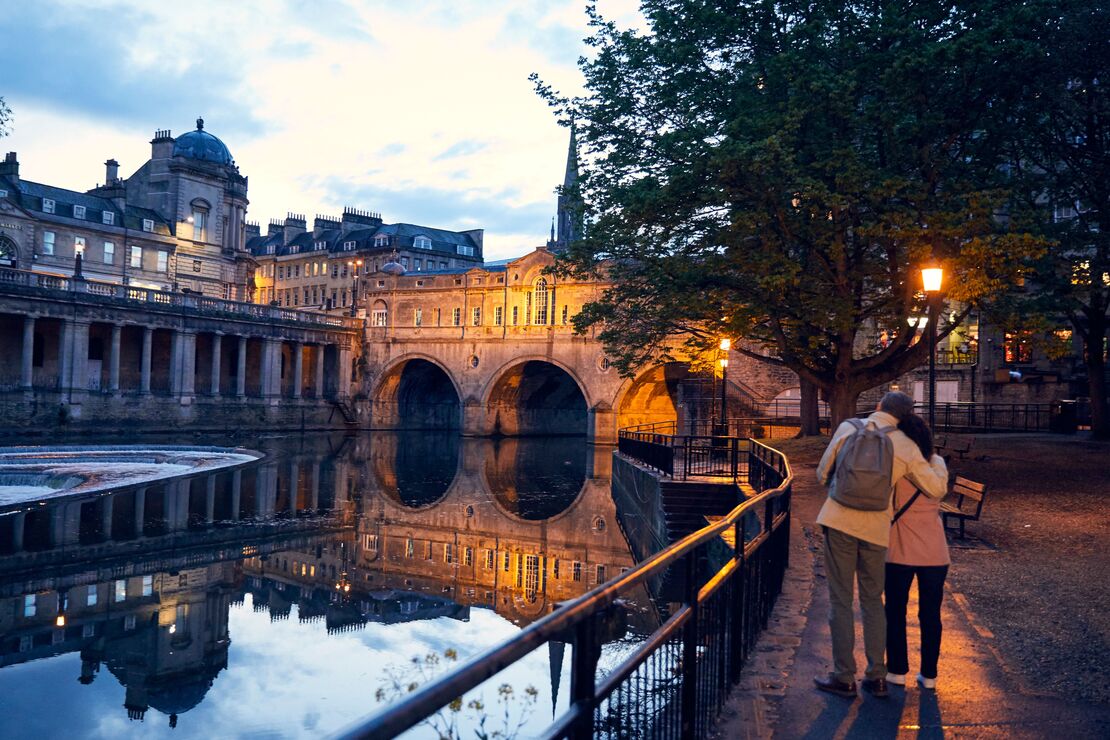 Couple strolling beside a canal in the evening