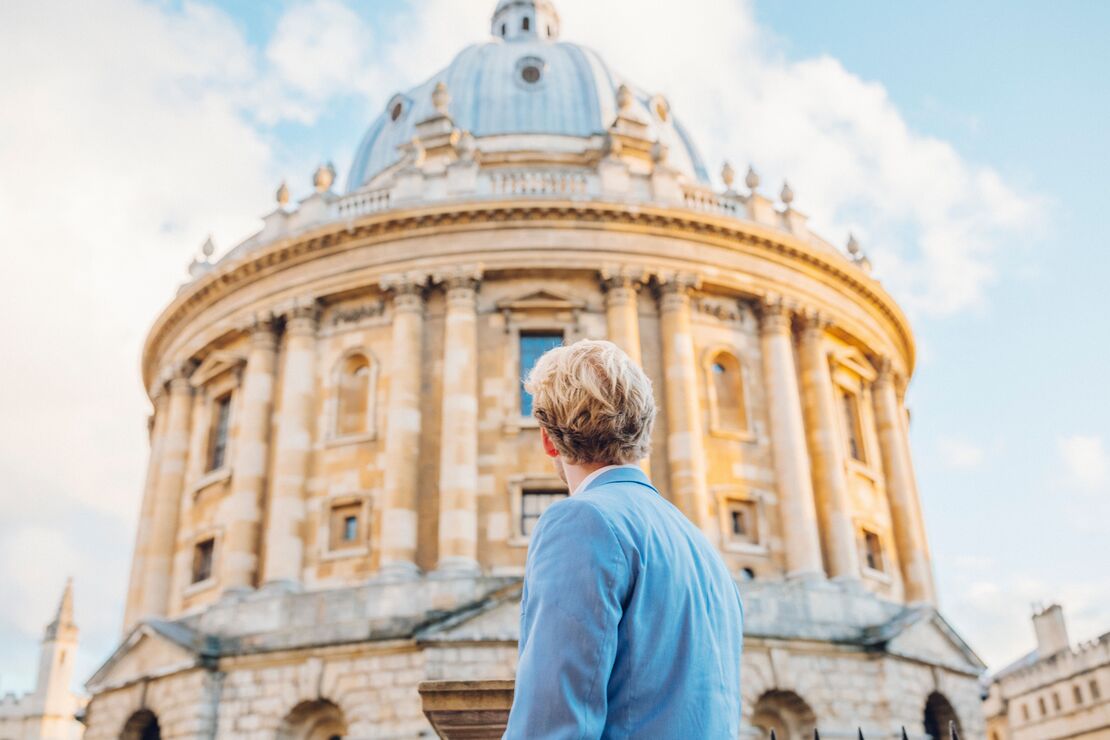Man looking up at a historical building with dome