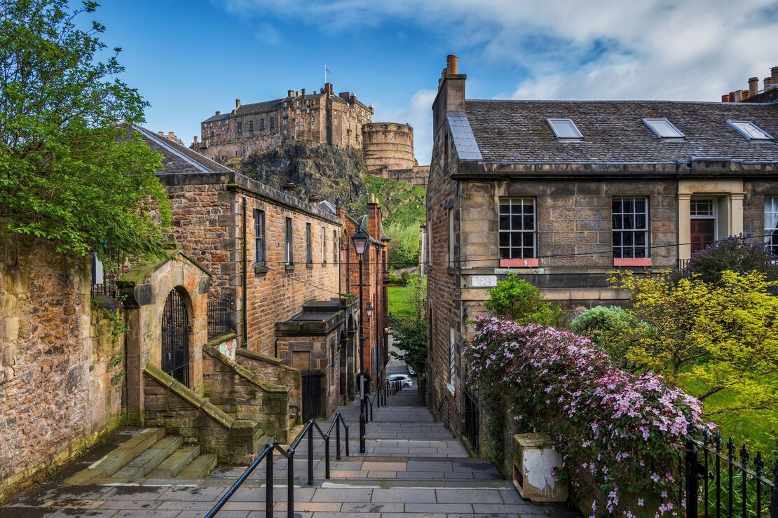 Edinburgh Castle viewed through narrow alley steps