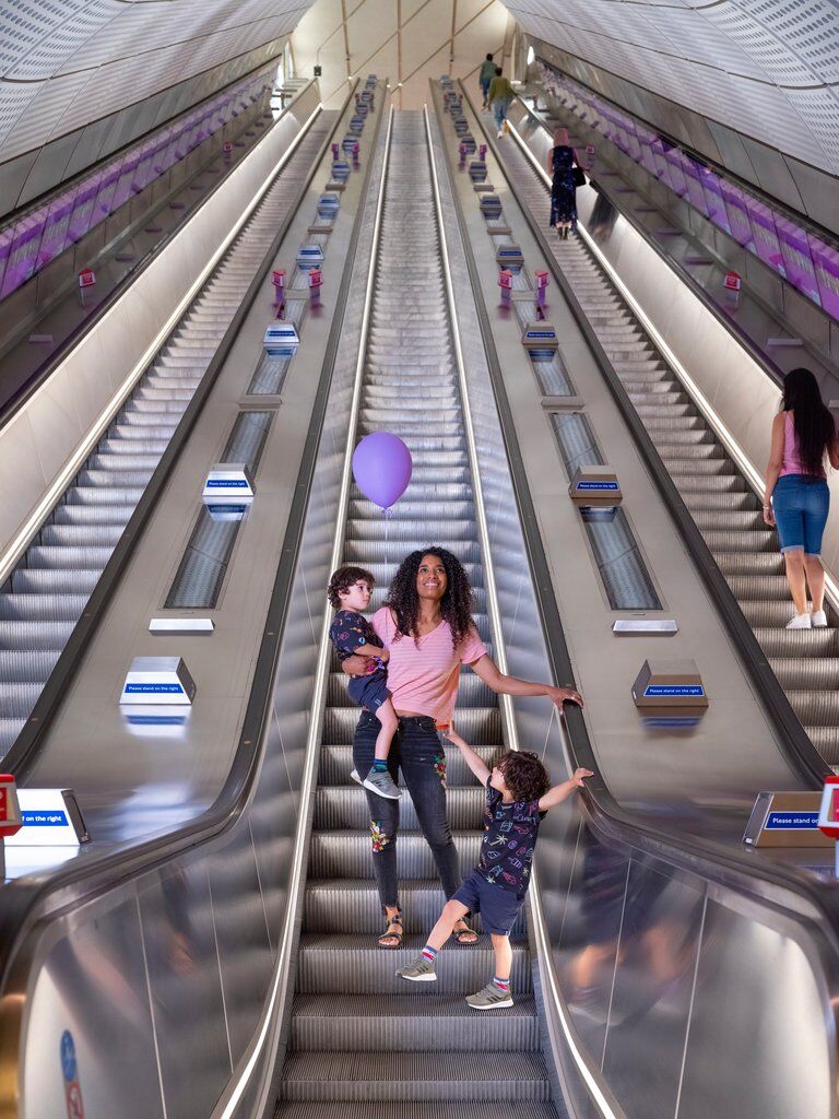 A family of three on one of the many escalators in the London underground