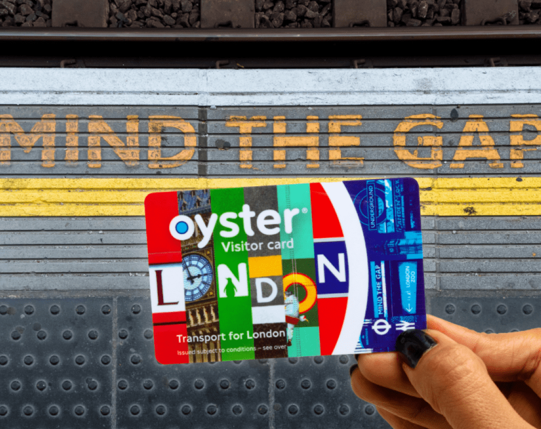 The Visitor Oyster card held at a station platform