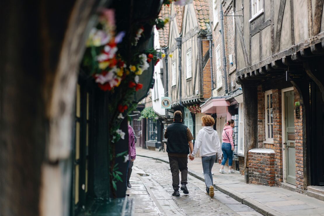 A couple walking down The Shambles in York