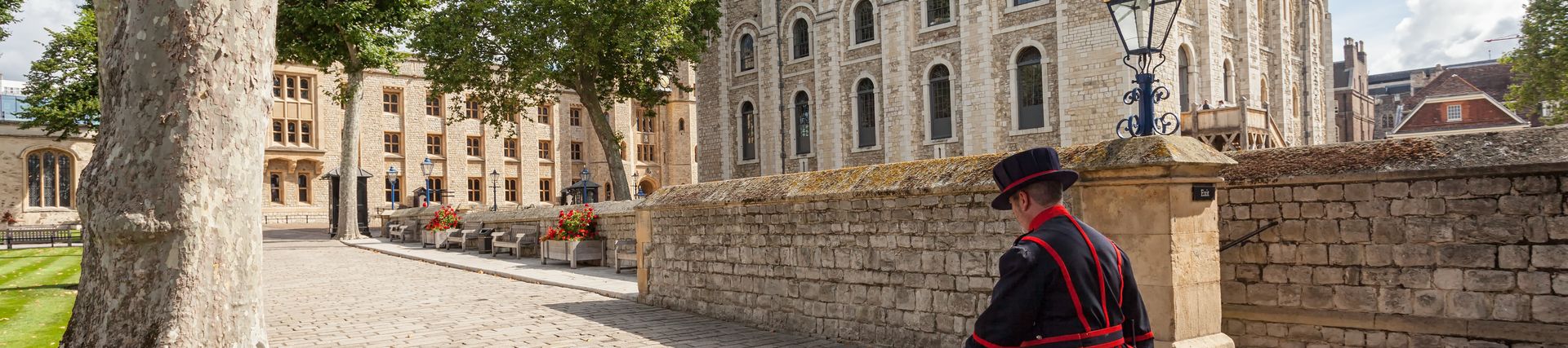 Beefeater walking by the, Tower of London on a sunny day