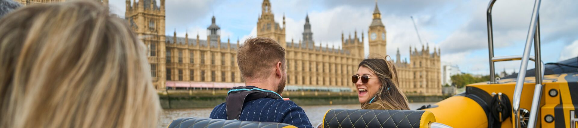 Group of people on board a speed boat on a city river