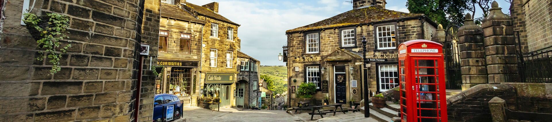 A view down a traditional cobbled street with a telephone box in view