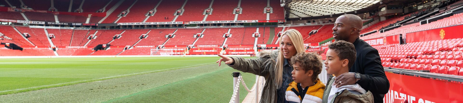 A family look out towards the pitch during a stadium tour