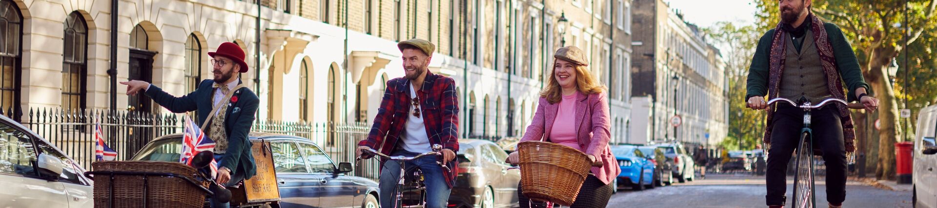 Four people on a guided tour on bicycles on a city road