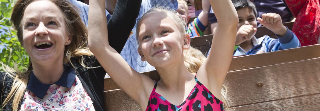 Children waving arms on rollercoaster at Gulliver's World