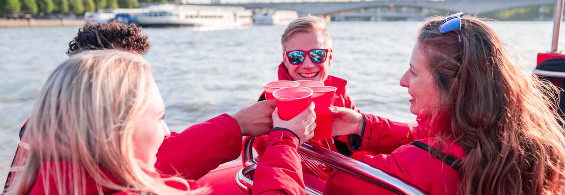 a_group_of_friends_having_a_drink_on_a_thames_rocket_speedboat