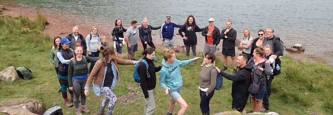 Hiking group outside lake in Brecon Beacons National Park