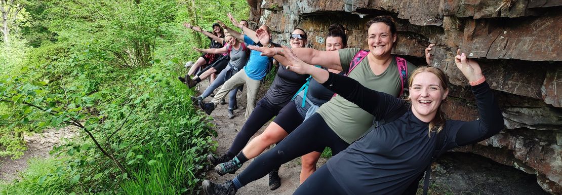 Hiking group posing for a picture in the woodlands of Brecon Beacons National Park