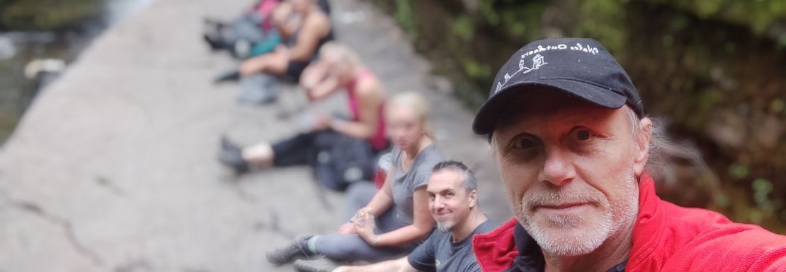 Hiking group posing for a picture in the woodlands of Brecon Beacons National Park