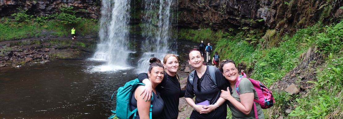 Tour group outside waterfall