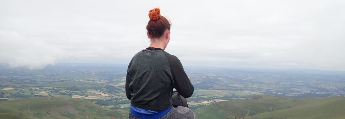 Hiker enjoying landscape views on their way up to Pen y Fan