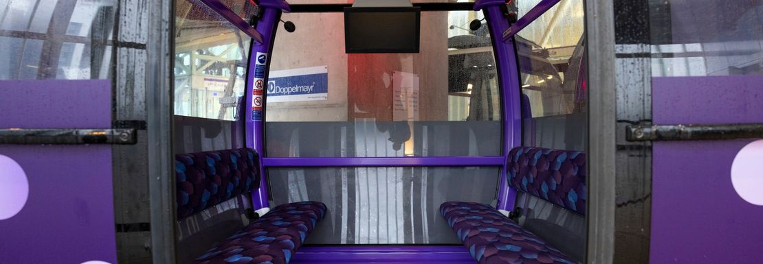 Purple seats inside the IFS Cloud Cable Car