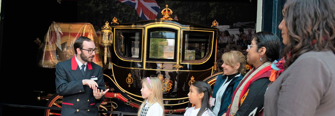 Guests at The Royal Mews listening to tour guide