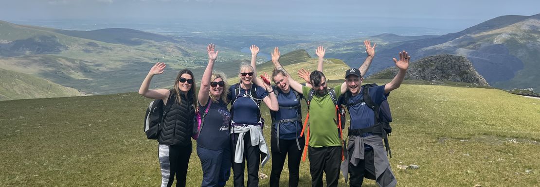 A group of hikers at Snowdonia are making the trip and showing their enjoyment of the nature