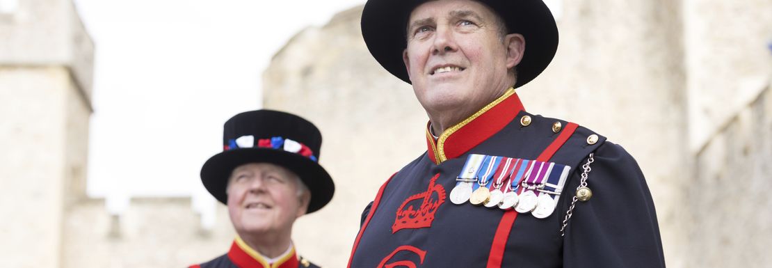 Warder guards at Tower of London wearing their Charles III logo on the front of their uniforms