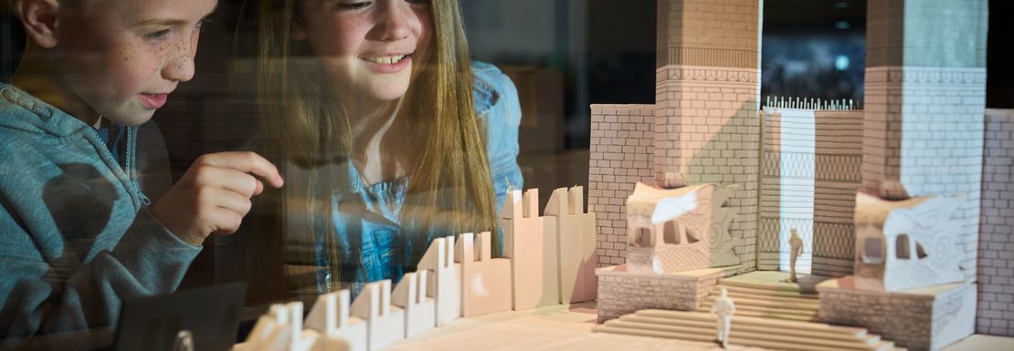 Two children look on at models of the Game of Thrones set