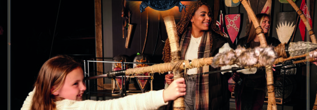 People stand next to the giant bows and arrows from Game of Thrones