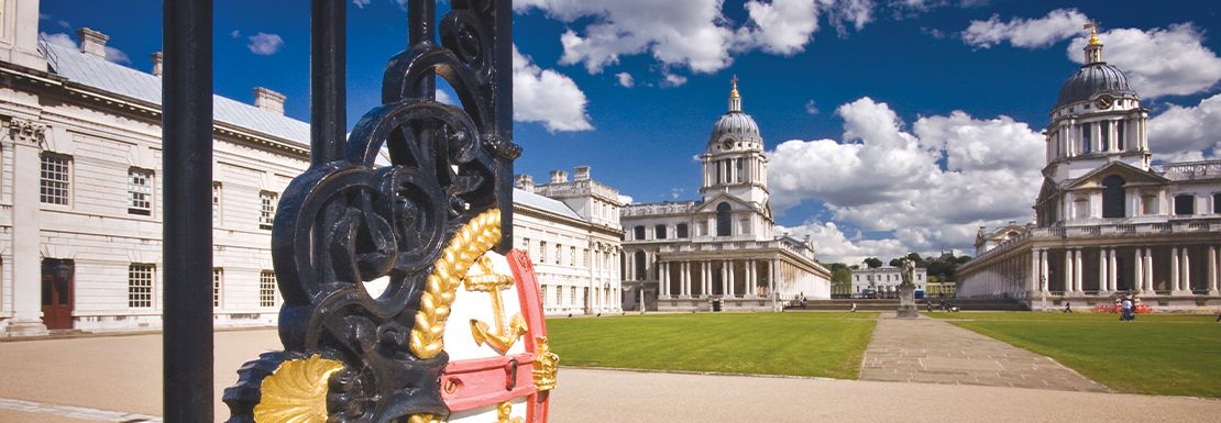 The grand gate leading into the Old Royal Naval College in a sunny afternoon