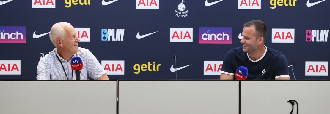 Two visitors sit at the press desk at Tottenham Hotspur's home stadium