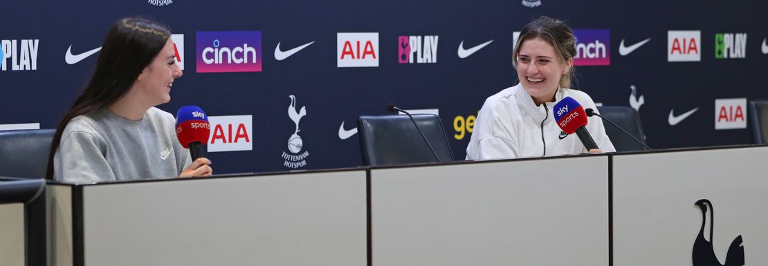 Two young lady fans at Tottenham sit where the players answer questions from the media