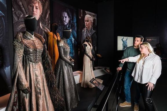 A woman points to a costume on display in the Game of Thrones tour