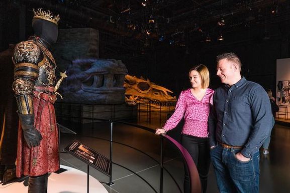 A couple look at a costume from the TV series Game of Thrones