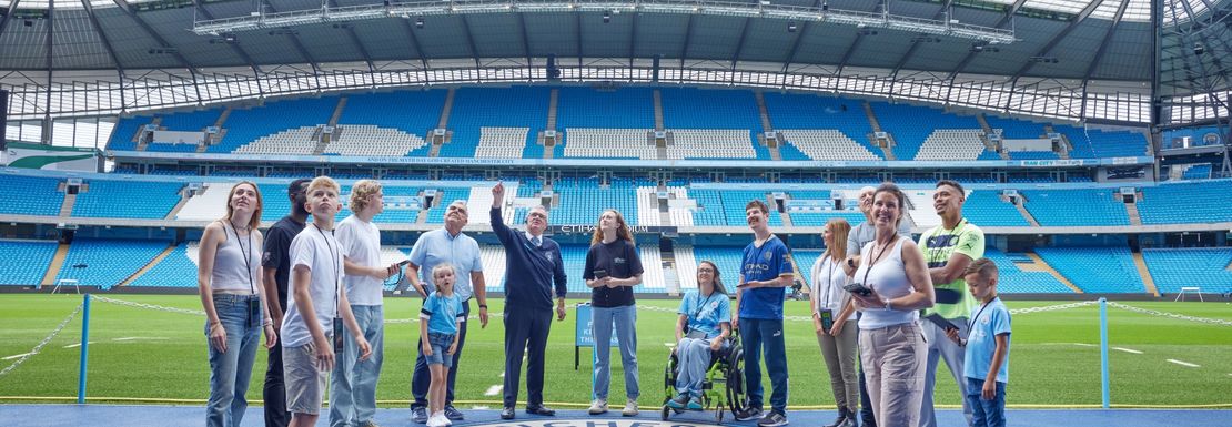 The Ethiad stadium visited by a group close to the pitch