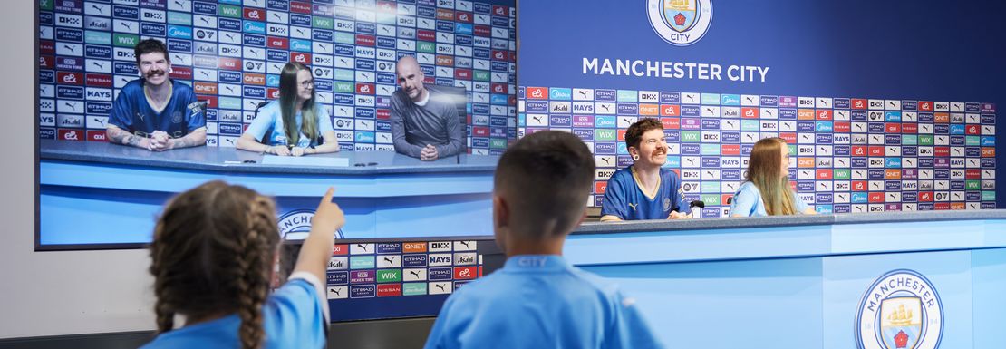 Two children look on in the press room of Manchester City