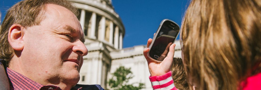 A family enjoys the sights of St Paul's Cathedral up close from the Big Bus Tour in London