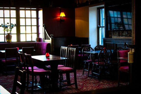 An interior shot of the seating inside the Tolbooth Tavern in Edinburgh