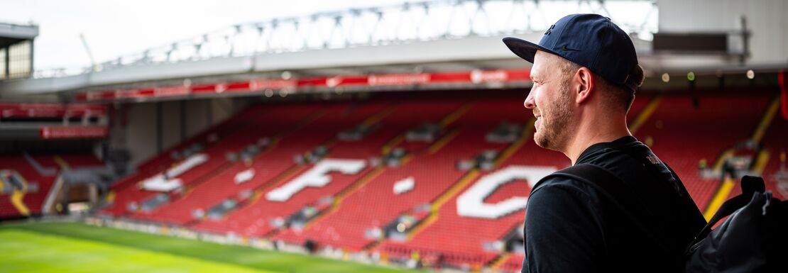 A fan looking out at the ground at the Anfield stadium, home to Liverpool FC