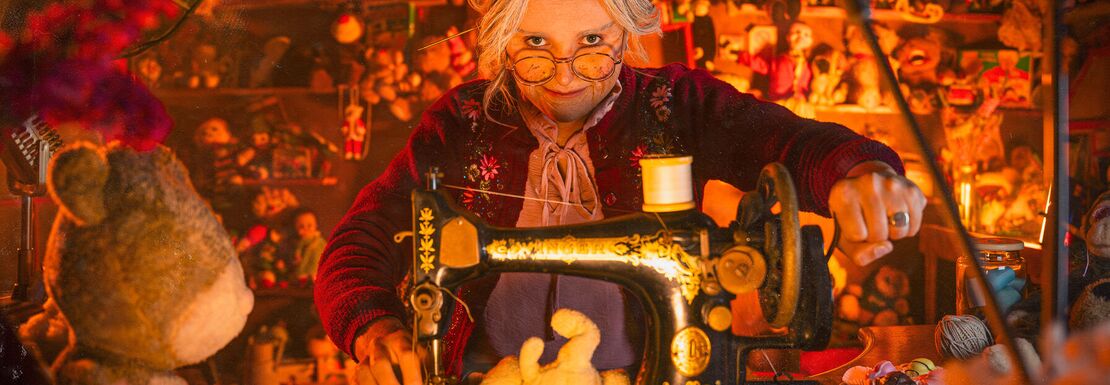 A spooky toymaker live actor inside her workshop at the at the Thorpe Park Fright Nights event