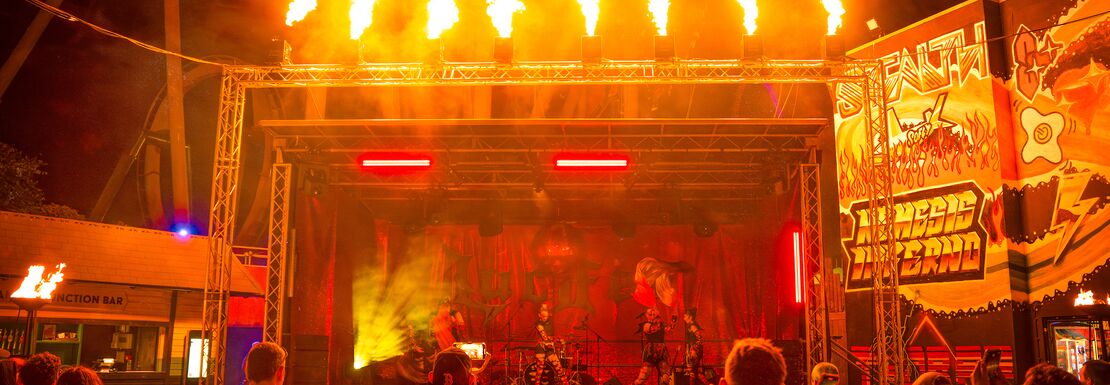 An audience watching a band perform on a fire-themed stage at the Thorpe Park Fright Nights event